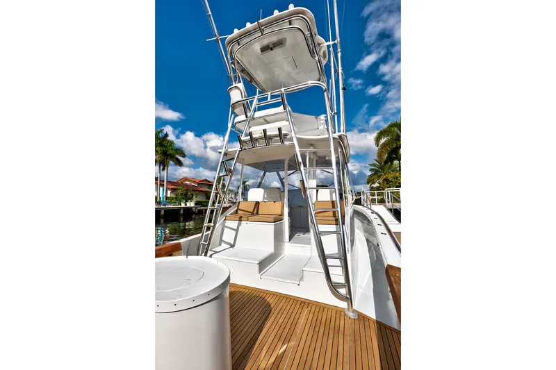 Slide: The Image of 2014 Release Walkaround boat with tower and seating, docked under a clear blue sky. - 13