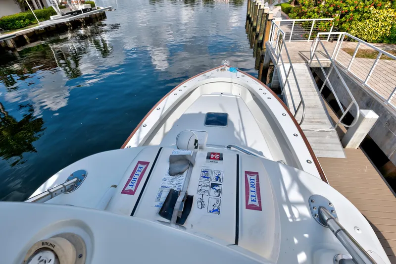 Slide: The Image of 2014 Release Walkaround boat docked by a serene waterfront. - 15