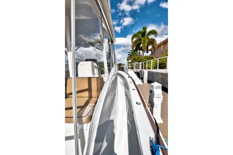 Slide: The Image of 2014 Release Walkaround boat docked, featuring sleek design and tropical backdrop. - 16