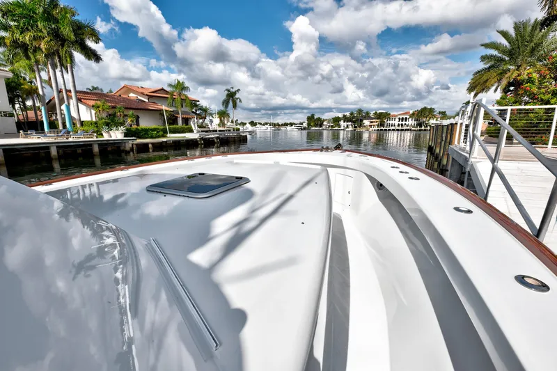 Slide: The Image of 2014 Release Walkaround boat docked by waterfront homes under a cloudy sky. - 17