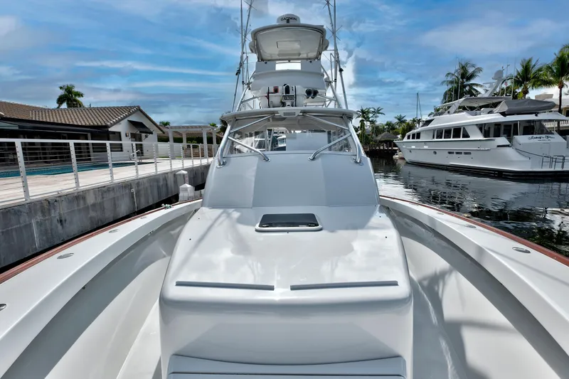 Slide: The Image of 2014 Release Walkaround boat docked, featuring sleek design and spacious deck under a clear sky. - 18