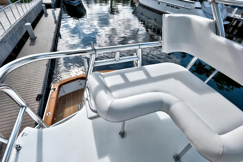 Slide: The Image of 2014 Release Walkaround boat with white seating and polished railings at a dock. - 22