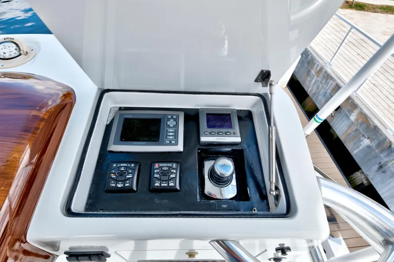 Slide: The Image of Control panel of a 2014 Release Walkaround boat with navigation instruments. - 24