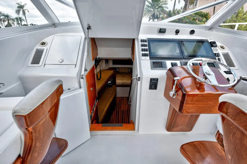 Slide: The Image of Luxurious 2014 Release Walkaround yacht cockpit with wooden helm and modern navigation equipment. - 26