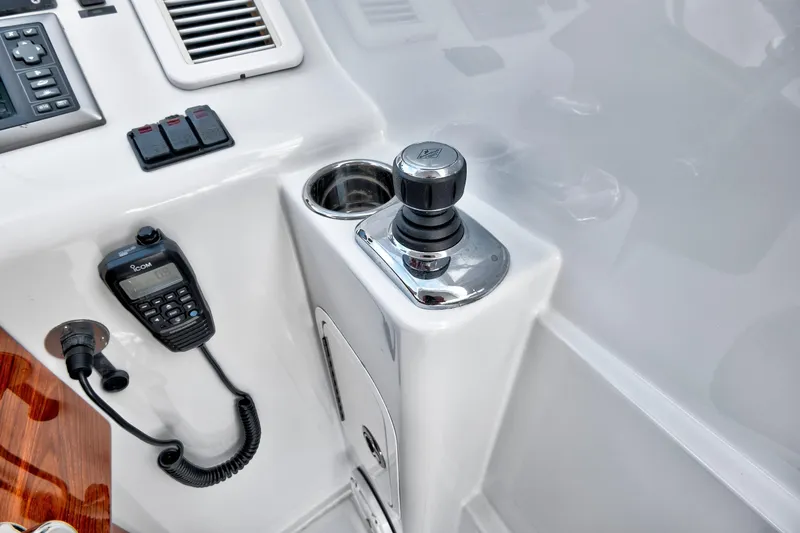 Slide: The Image of Boat control panel with joystick, radio, and switches on a 2014 Release Walkaround. - 29