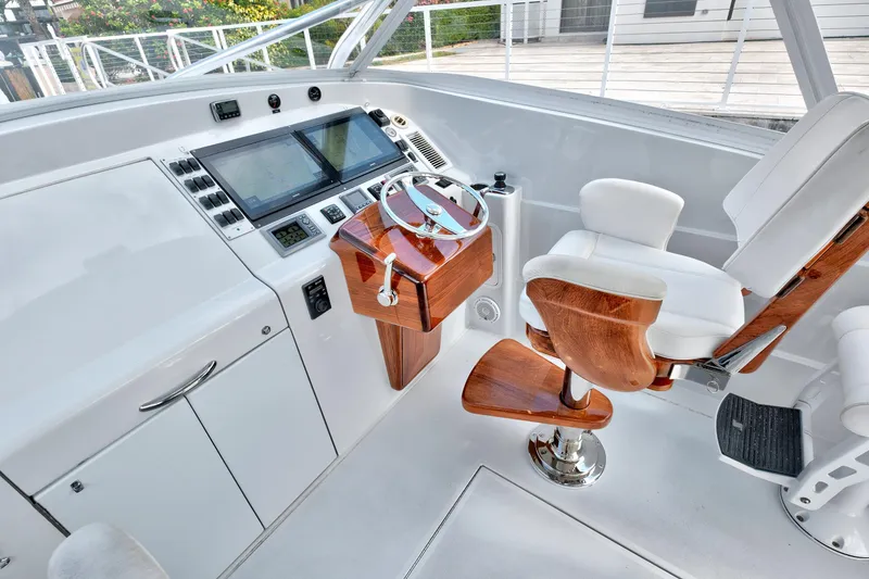 Slide: The Image of Luxurious 2014 Release Walkaround yacht helm with wooden accents and modern navigation controls. - 31