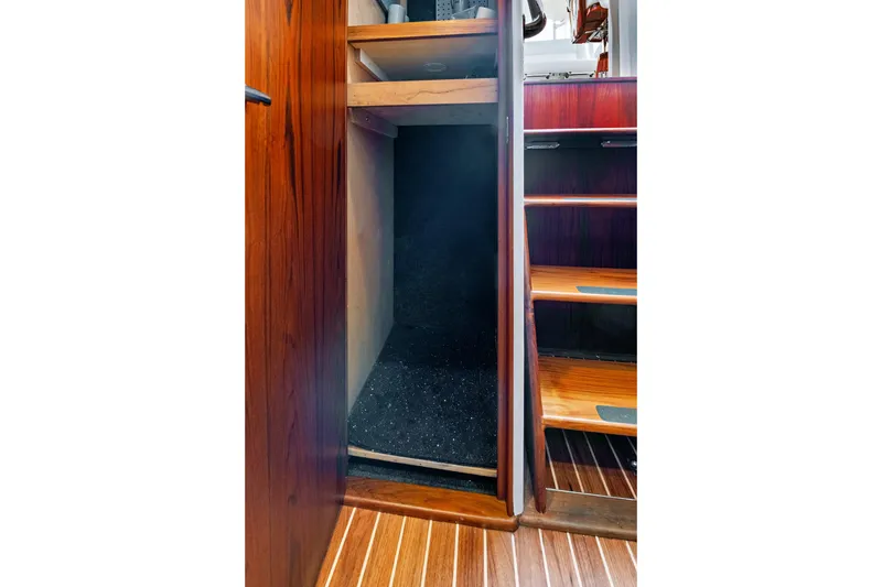 Slide: The Image of Wooden interior of 2014 Release Walkaround boat with open storage compartment. - 35