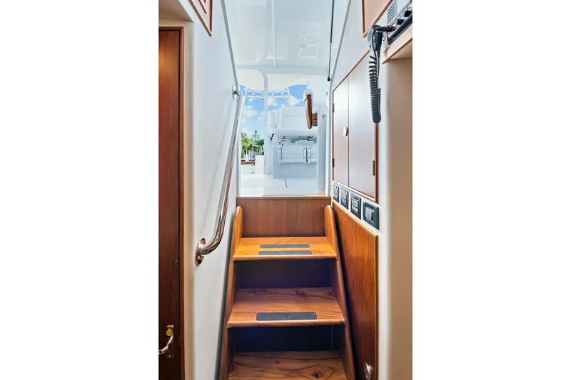 Slide: The Image of Staircase inside 2014 Release Walkaround boat, leading to upper deck with wooden finish. - 36