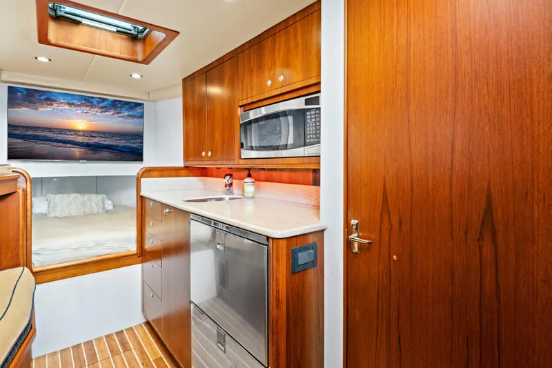 Slide: The Image of Luxurious 2014 Release Walkaround yacht interior with wood cabinetry and modern appliances. - 38