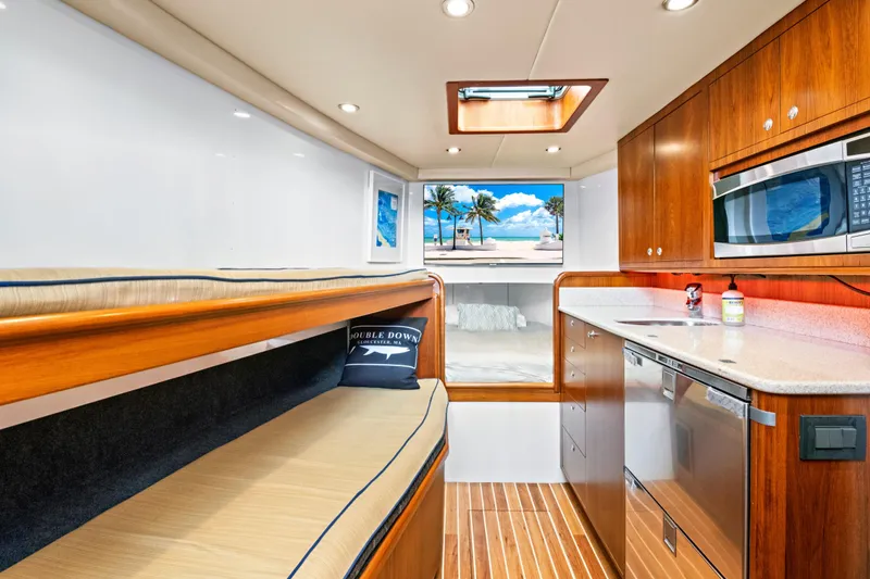 Slide: The Image of Luxurious 2014 Release Walkaround yacht interior with wood cabinetry, kitchenette, and scenic window view. - 39