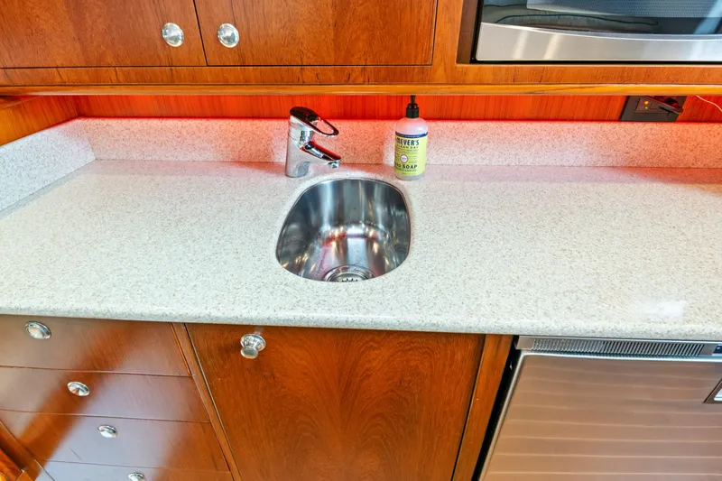 Slide: The Image of Modern yacht kitchen with stainless steel sink, wooden cabinets, and countertop, 2014 Release Walkaround. - 40
