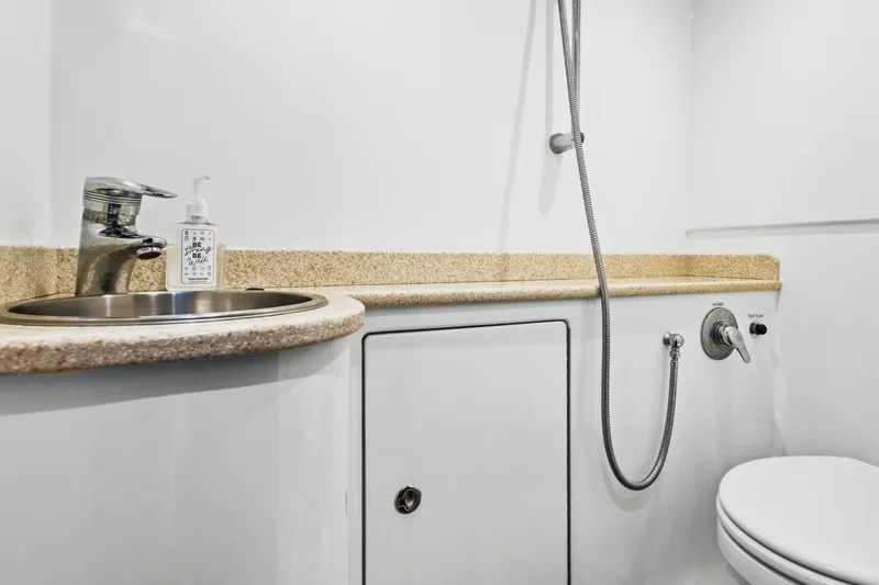 Slide: The Image of Compact boat bathroom with sink, faucet, and showerhead in a 2014 Release Walkaround model. - 48