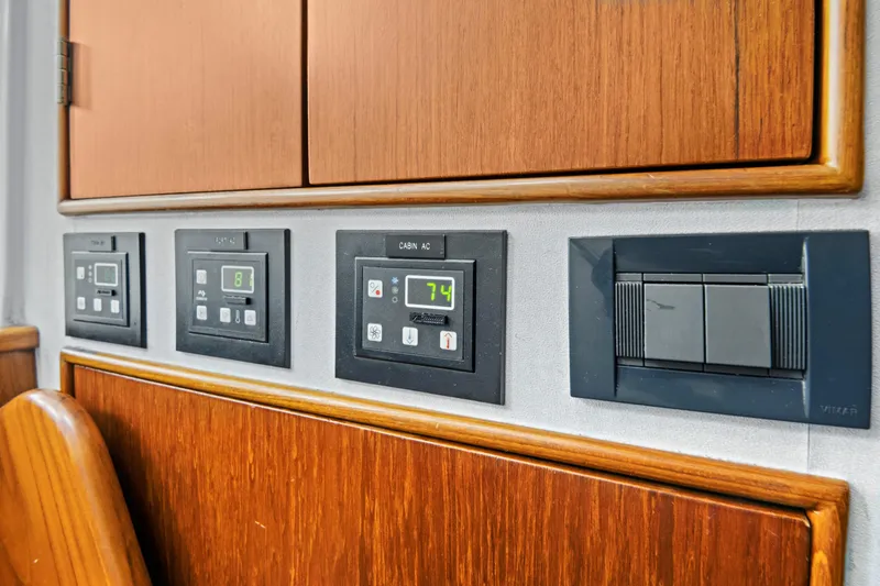 Slide: The Image of Control panel on a 2014 Release Walkaround boat with wooden cabinetry. - 52