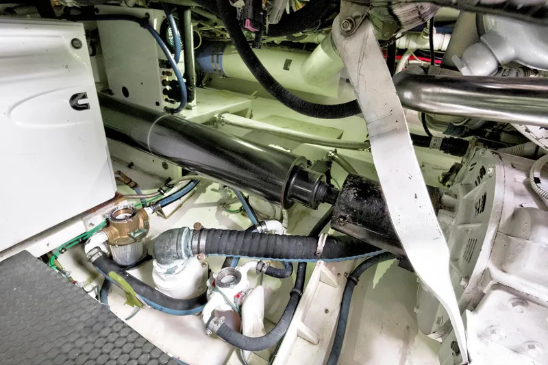 Slide: The Image of Engine room of a 2014 Release Walkaround boat, showcasing mechanical components and piping. - 63