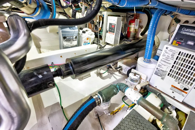 Slide: The Image of Engine room of a 2014 Release Walkaround boat with Cummins generator and various components. - 64
