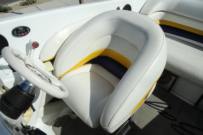 Slide: The Image of 1998 Baja 29 Outlaw boat cockpit with white and yellow seating. - 11