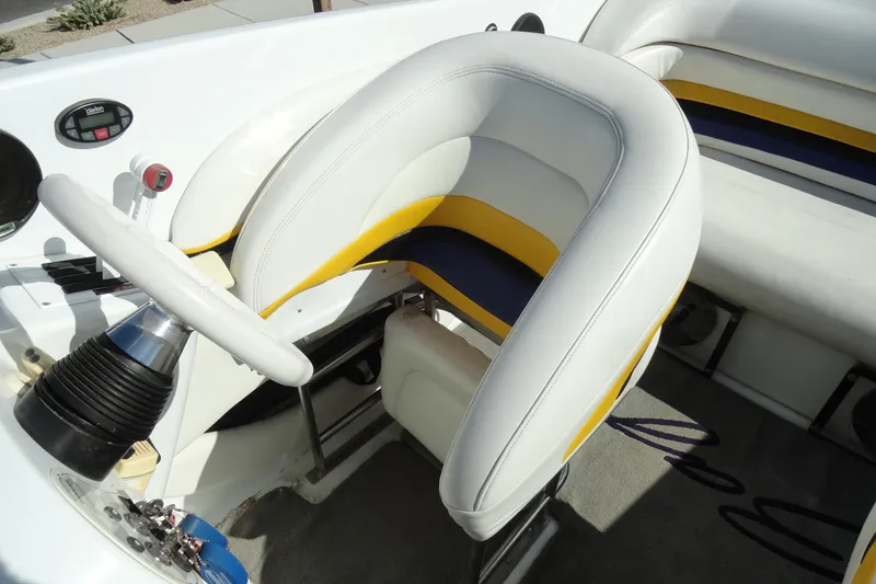 Slide: The Image of Interior of a 1998 Baja 29 Outlaw boat with white and yellow seating. - 12