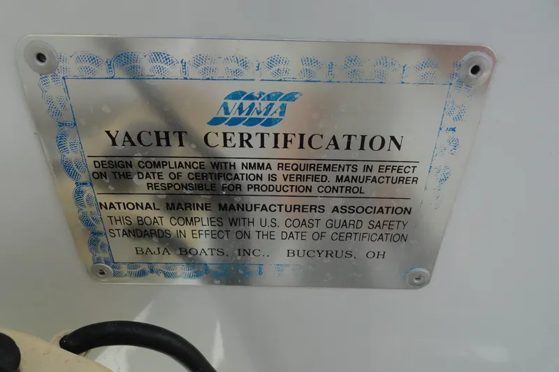 Slide: The Image of 1998 Baja 29 Outlaw yacht certification plaque, NMMA compliance, U.S. Coast Guard standards. - 13