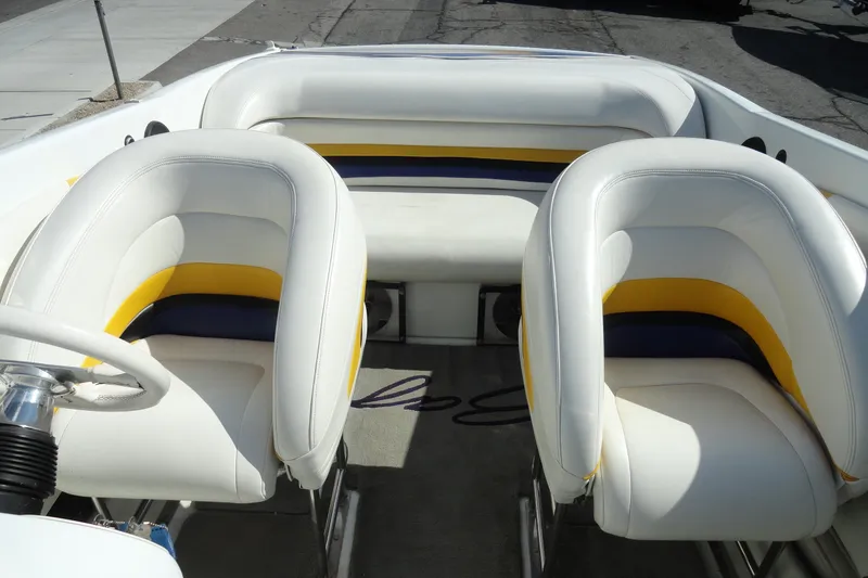 Slide: The Image of 1998 Baja 29 Outlaw boat interior with white and yellow seating. - 22