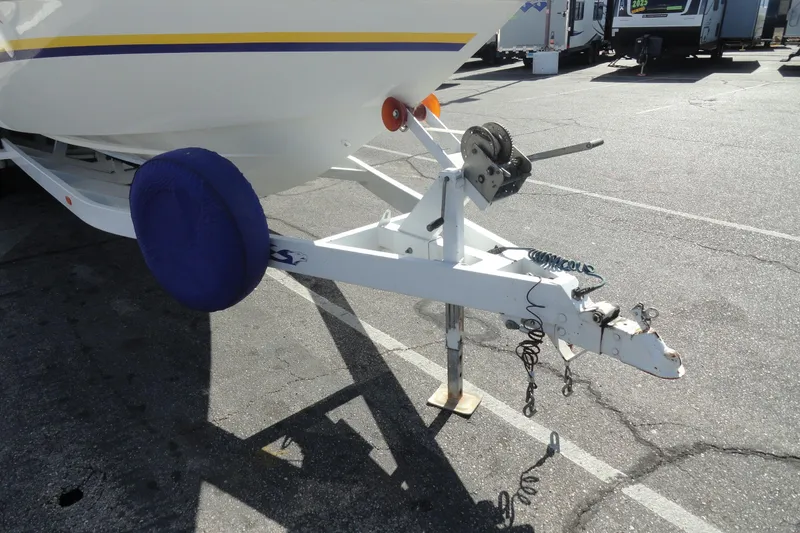 Slide: The Image of 1998 Baja 29 Outlaw boat trailer hitch with winch in parking lot. - 25