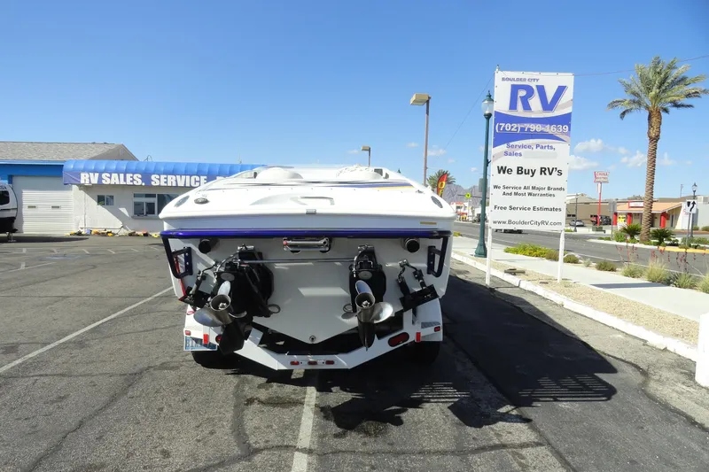 Slide: The Image of 1998 Baja 29 Outlaw boat parked near RV sales and service center. - 26