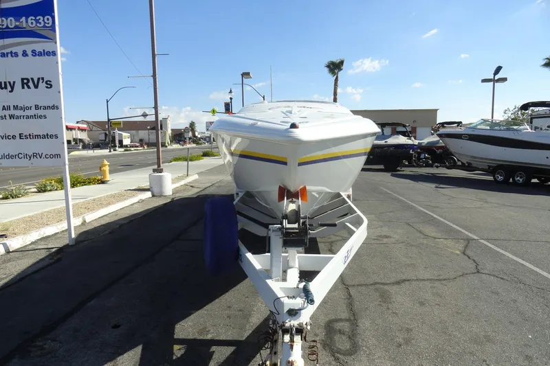 Slide: The Image of 1998 Baja 29 Outlaw boat on trailer in parking lot, sunny day. - 3