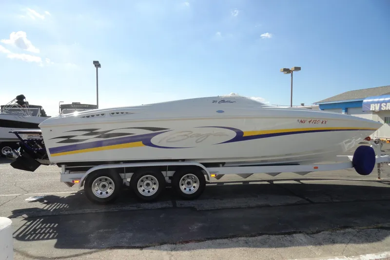 Slide: The Image of 1998 Baja 29 Outlaw speedboat on trailer, featuring sleek design and vibrant graphics. - 5