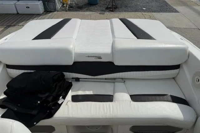 Slide: The Image of 2009 Glastron GT 185 boat interior with white and black seating. - 10