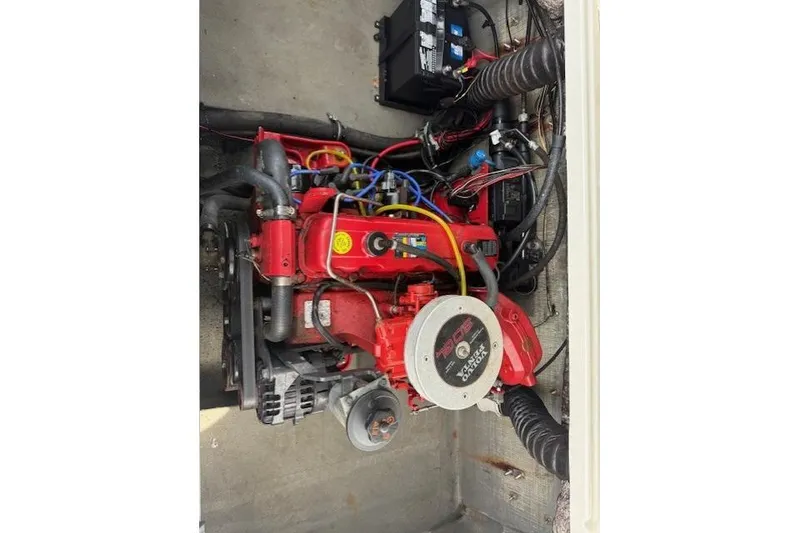 Slide: The Image of 2009 Glastron GT 185 boat engine, featuring a red motor and connected components. - 11