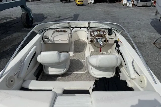 Slide: The Image of 2009 Glastron GT 185 boat interior with white seating and dashboard controls. - 4