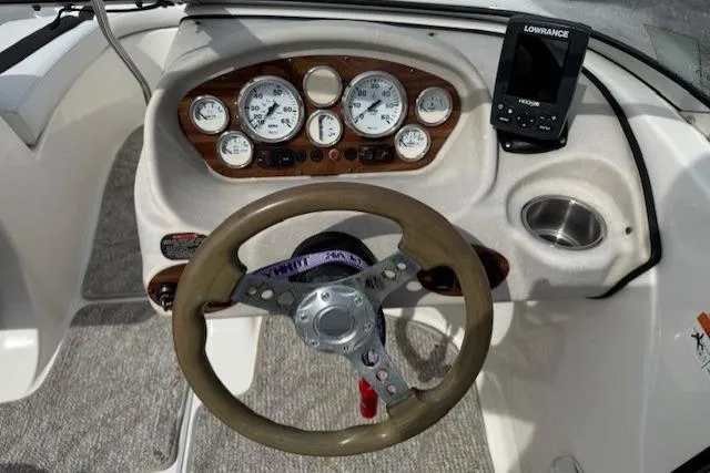 Slide: The Image of 2009 Glastron GT 185 boat dashboard with steering wheel and Lowrance device. - 6