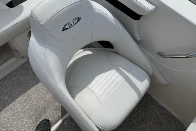 Slide: The Image of White leather seat in a 2009 Glastron GT 185 boat interior. - 8