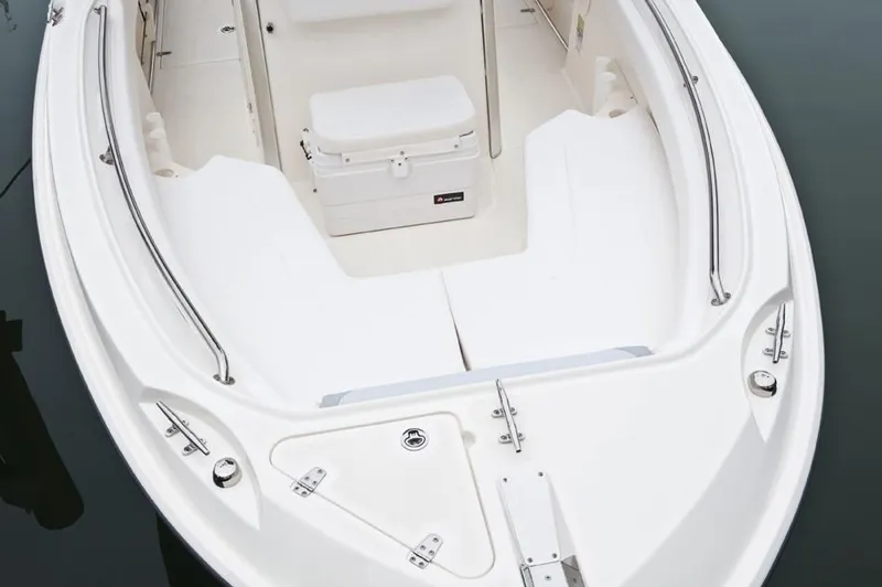 Slide: The Image of 2014 Boston Whaler 220 Outrage boat bow seating and storage compartments. - 9