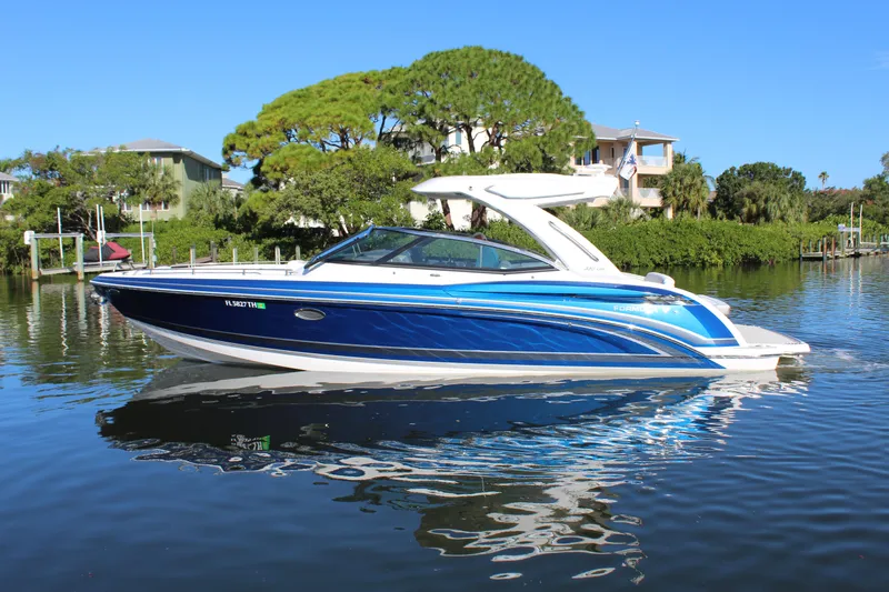 The Image of 2023 Formula 330 Crossover Bowrider in a scenic waterway setting. - 0