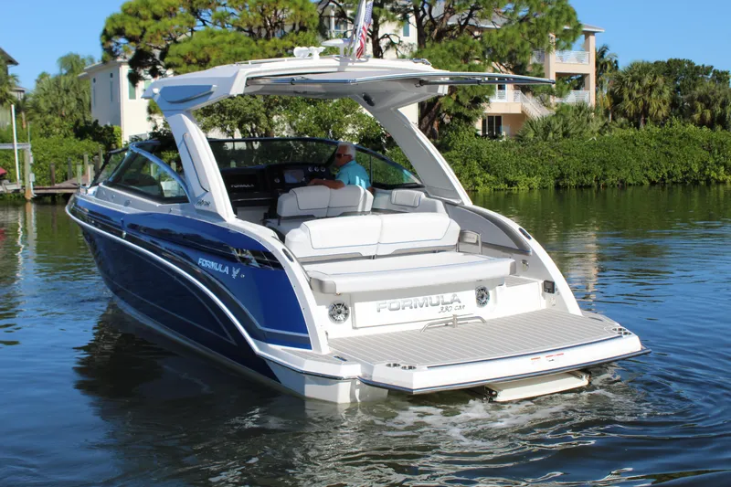 Slide: The Image of 2023 Formula 330 Crossover Bowrider on water, showcasing sleek design and luxury features. - 14