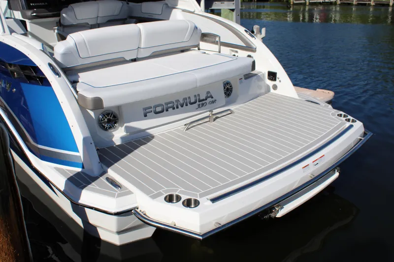 Slide: The Image of 2023 Formula 330 Crossover Bowrider boat with spacious rear deck on water. - 15