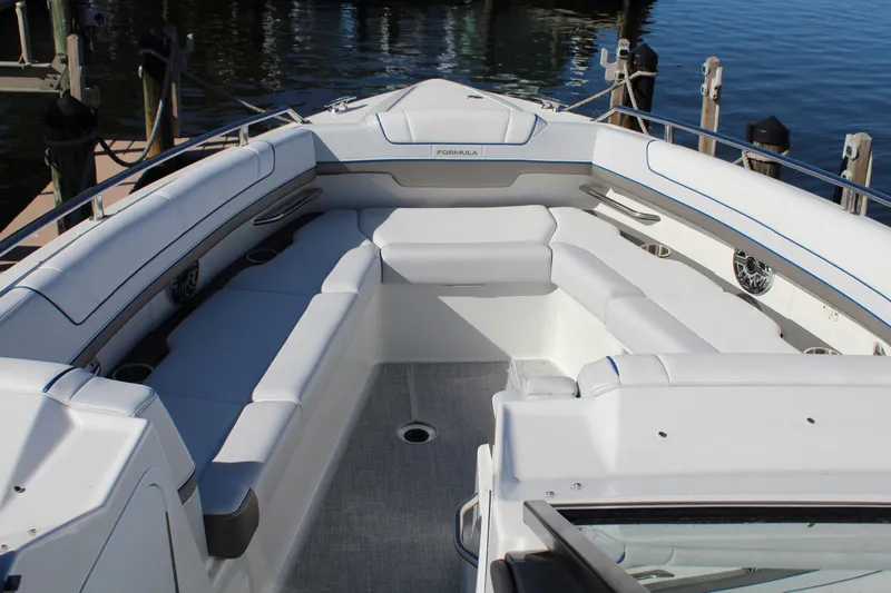 Slide: The Image of 2023 Formula 330 Crossover Bowrider with spacious seating at the dock. - 18