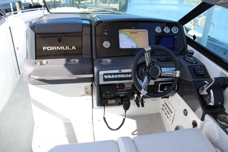 Slide: The Image of 2023 Formula 330 Crossover Bowrider dashboard with navigation system and steering wheel. - 23