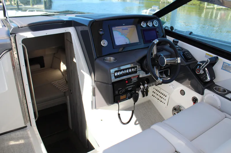 Slide: The Image of 2023 Formula 330 Crossover Bowrider cockpit with modern controls and cabin view. - 33