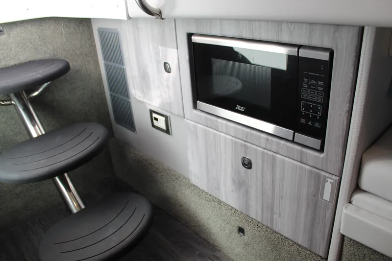Slide: The Image of 2023 Formula 330 Crossover Bowrider interior with microwave and seating area. - 36