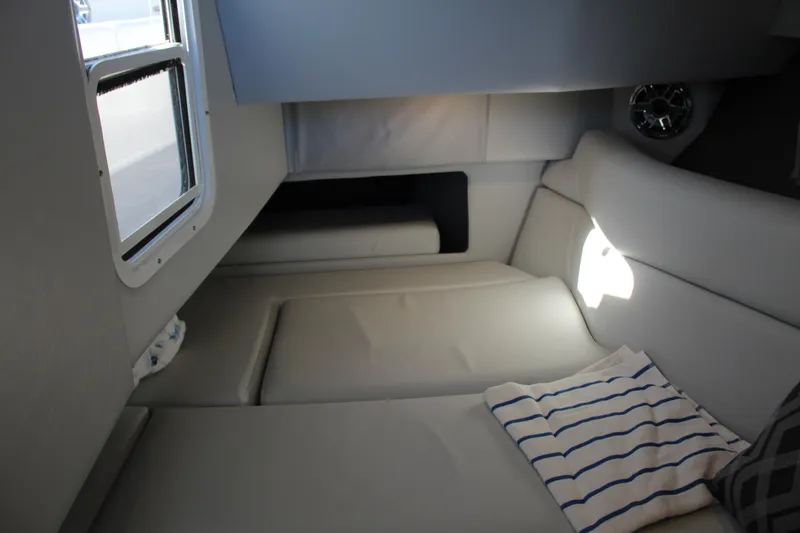 Slide: The Image of 2023 Formula 330 Crossover Bowrider interior cabin with comfortable seating and window view. - 37
