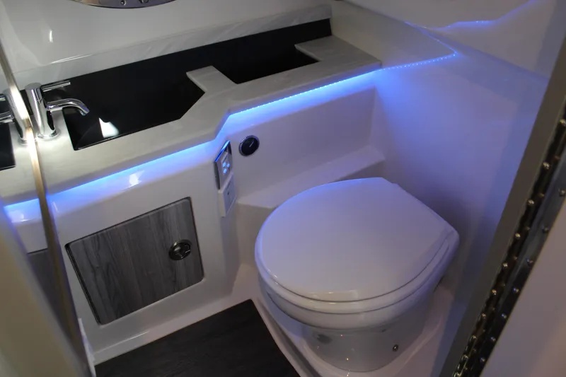 Slide: The Image of 2023 Formula 330 Crossover Bowrider bathroom with modern fixtures and ambient lighting. - 41