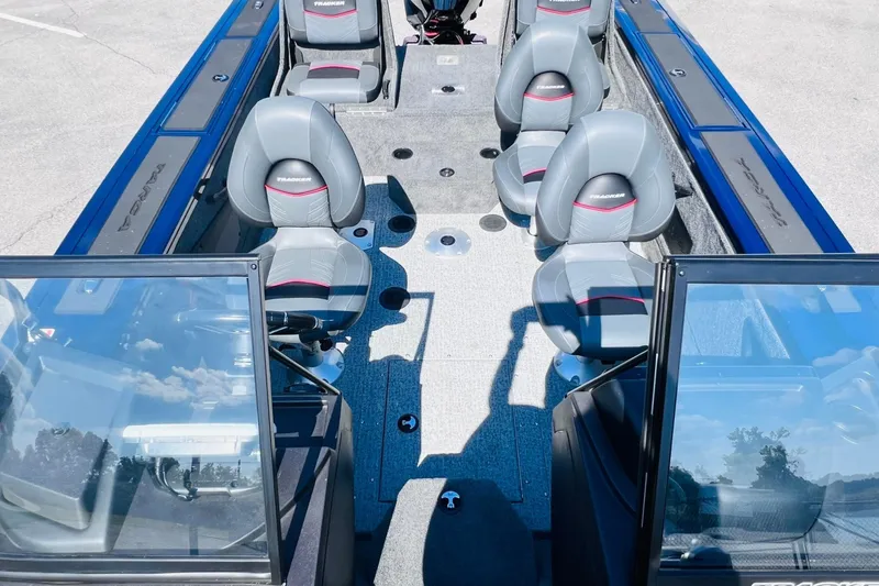 Slide: The Image of 2024 Tracker Targa V-18 Combo boat interior with seating and windshield view. - 13