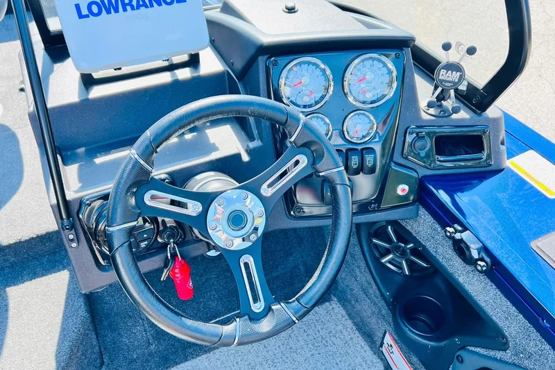 Slide: The Image of 2024 Tracker Targa V-18 Combo boat dashboard with steering wheel and gauges. - 19