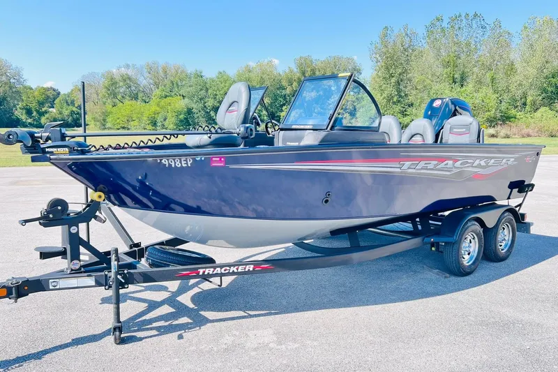 Slide: The Image of 2024 Tracker Targa V-18 Combo boat on trailer, parked outdoors. - 2