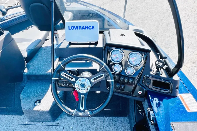 Slide: The Image of 2024 Tracker Targa V-18 Combo boat dashboard with steering wheel and Lowrance display. - 20