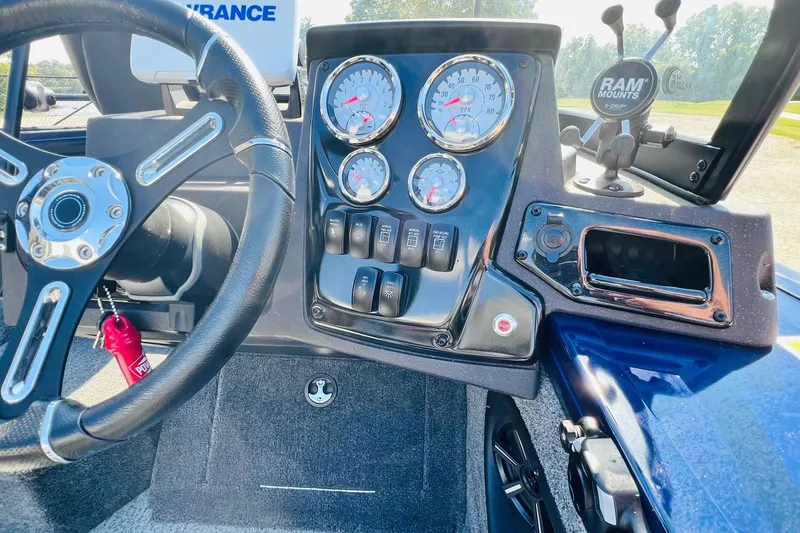 Slide: The Image of 2024 Tracker Targa V-18 Combo dashboard with steering wheel and instrument panel. - 21