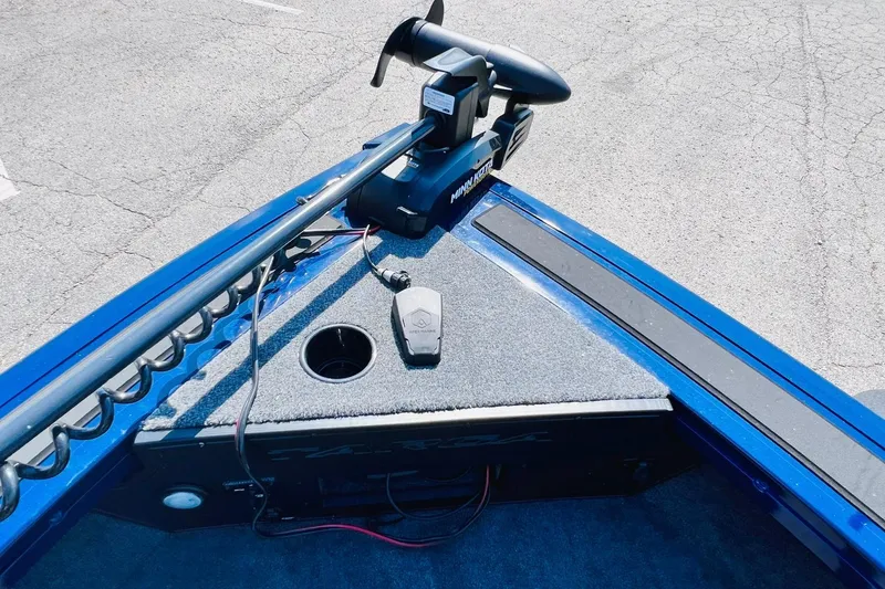 Slide: The Image of 2024 Tracker Targa V-18 Combo boat with Minn Kota trolling motor on blue deck. - 28