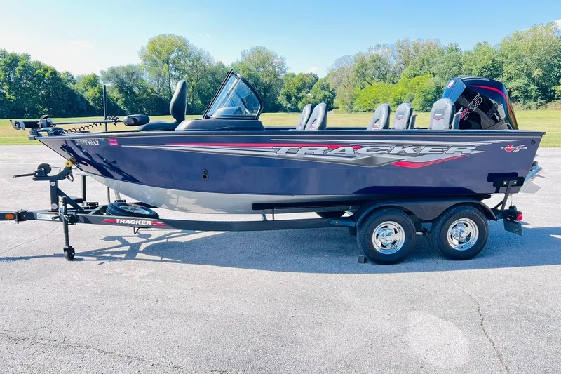 Slide: The Image of 2024 Tracker Targa V-18 Combo boat on trailer, parked outdoors. - 3