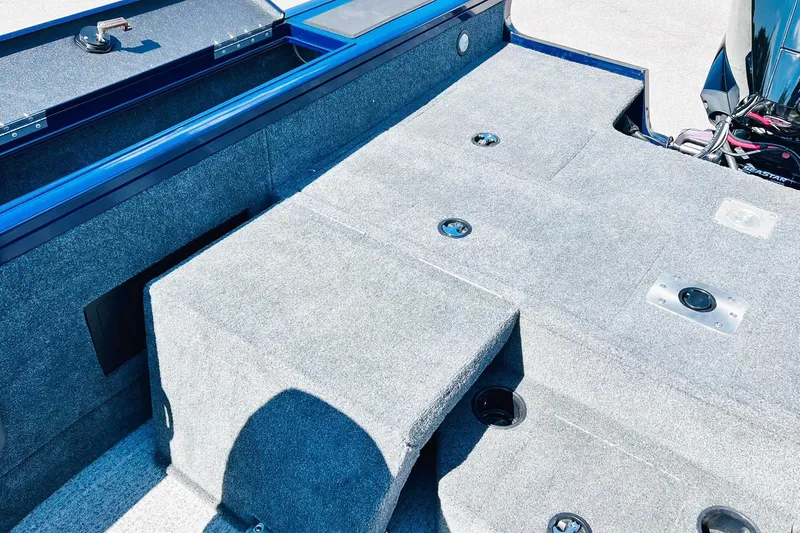 Slide: The Image of 2024 Tracker Targa V-18 Combo boat interior with carpeted deck and storage compartments. - 34